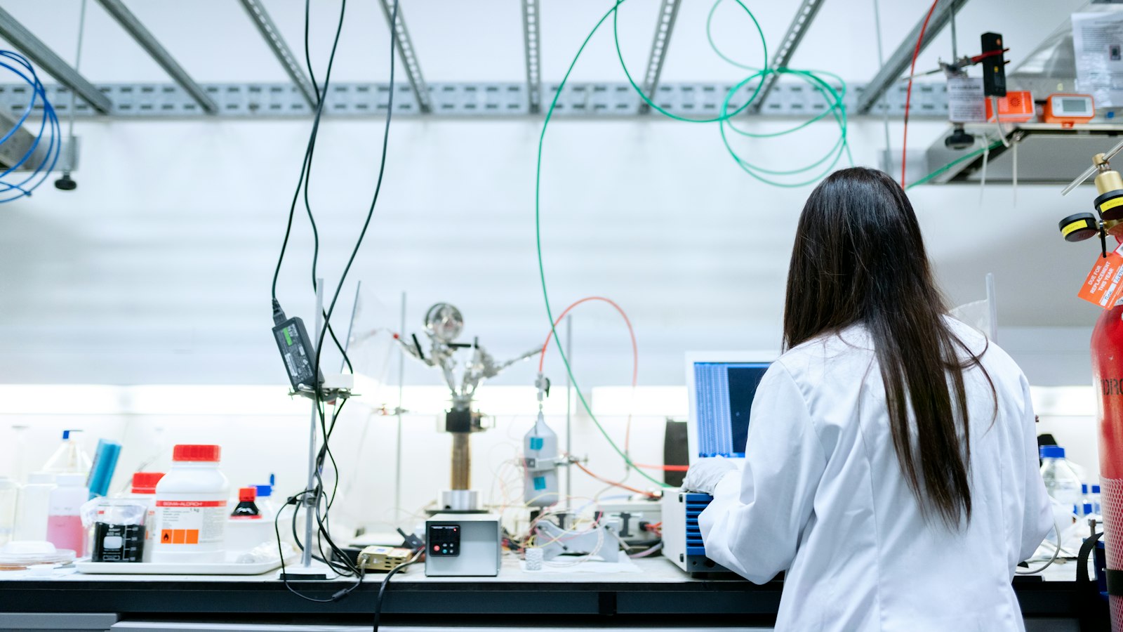A scientist works at a laptop in a laboratory