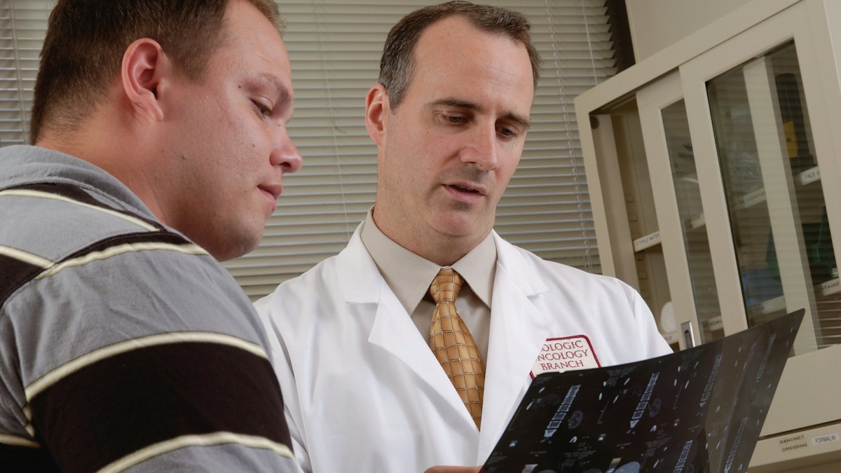 A doctor reviews information on a tablet