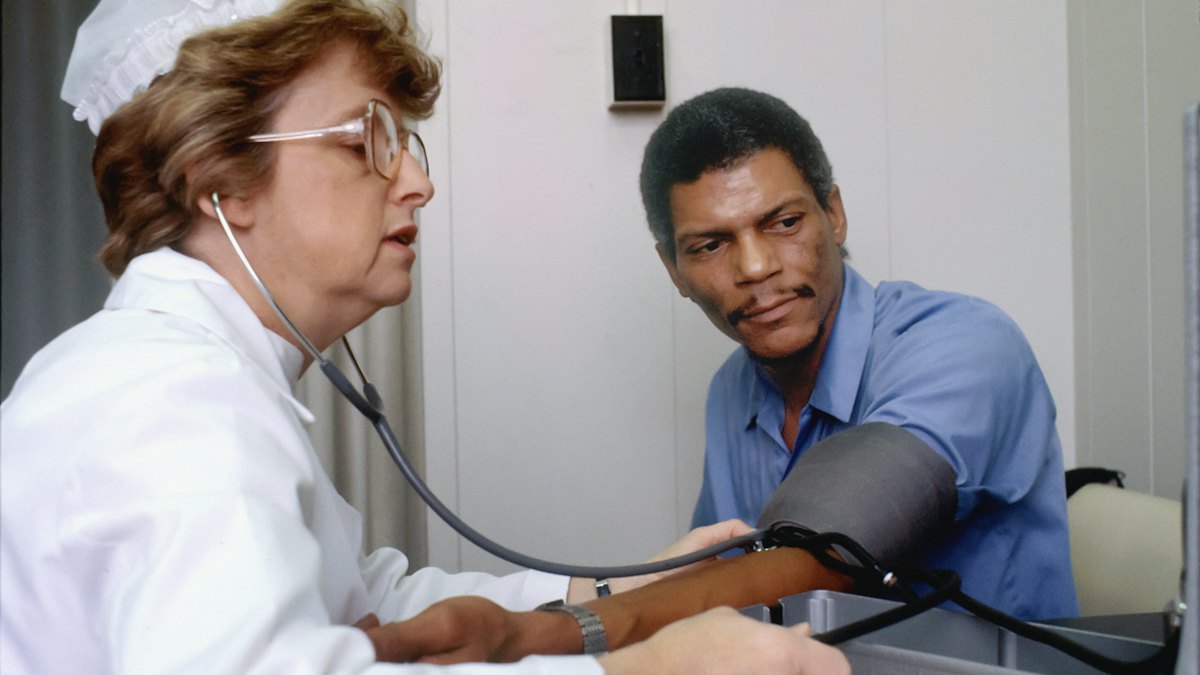 A nurse checks a patient’s blood pressure in a clinic